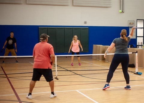 group of people playing pickleball 