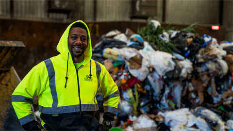 Solid waste worker smiling
