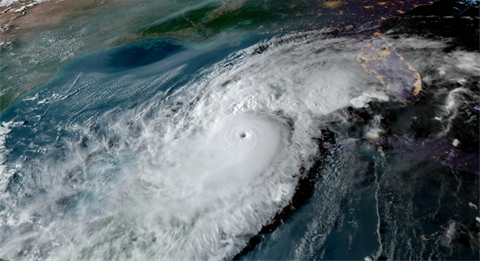 Satellite image of a large, well-defined hurricane with a visible eye over the Gulf of Mexico, approaching the southeastern United States, including Florida. 