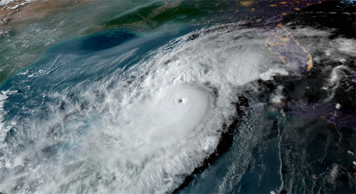 Satellite image of a large, well-defined hurricane with a visible eye over the Gulf of Mexico, approaching the southeastern United States, including Florida. 