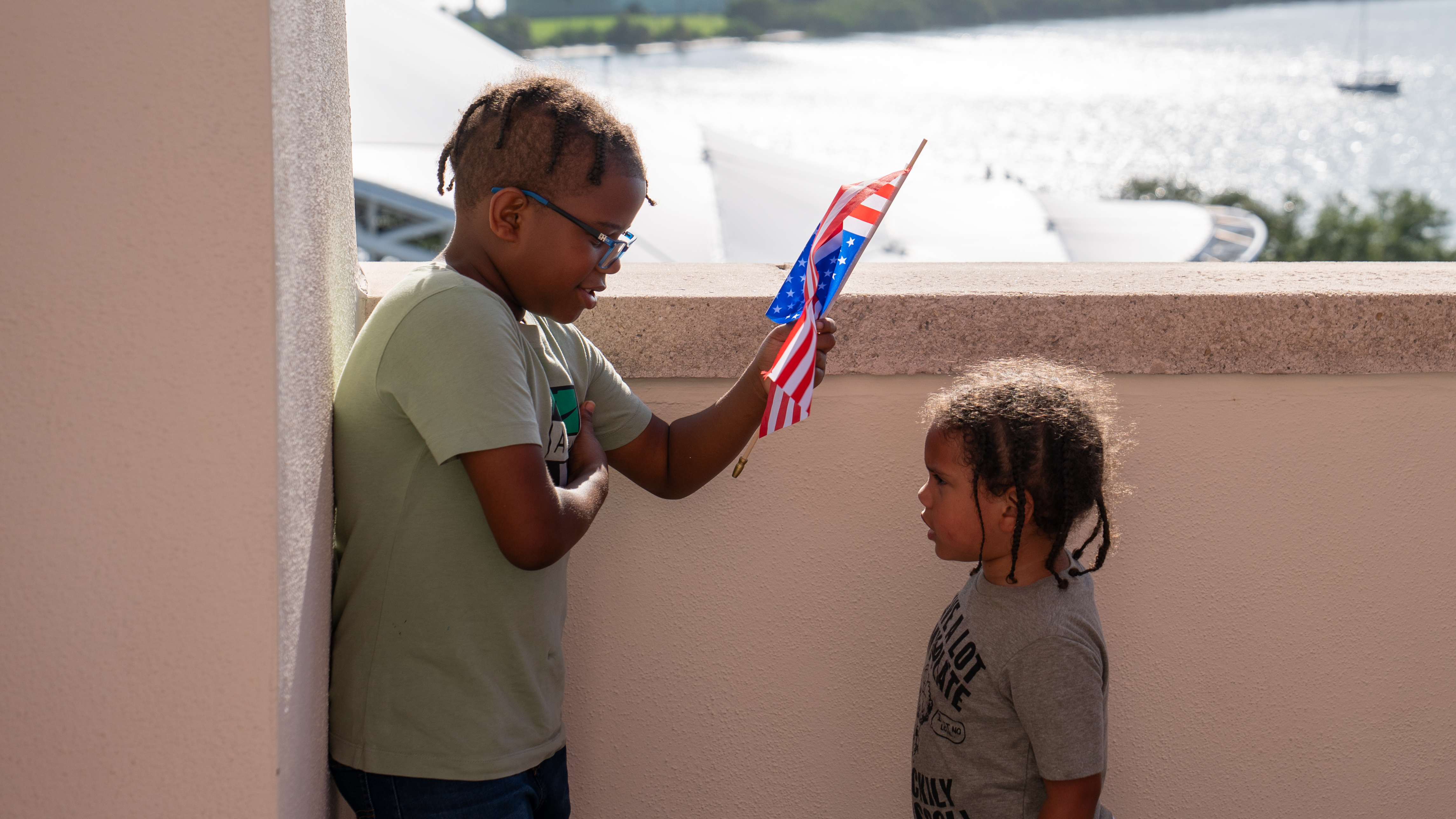 Children at the rooftop event holding American flag