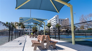 Large sun shades between tennis courts