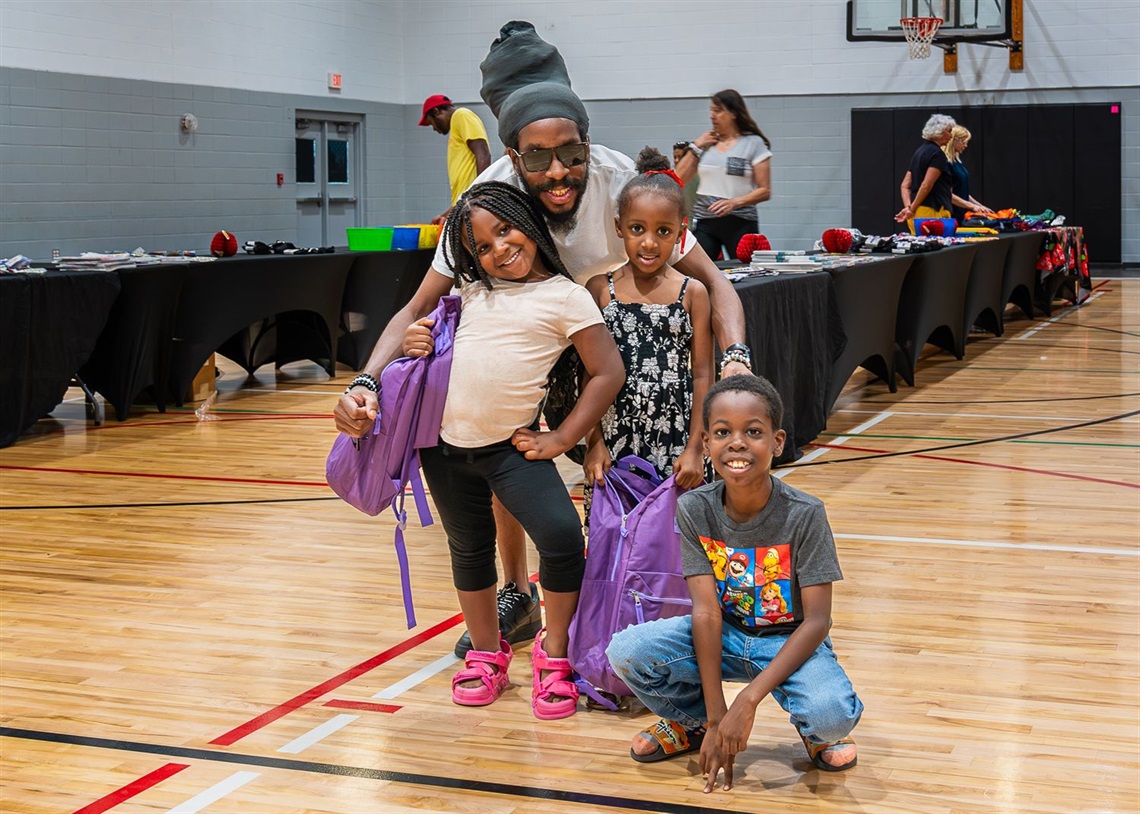 Ross Norton Back 2 School Backpack Giveaway photo of a family with their free backpacks