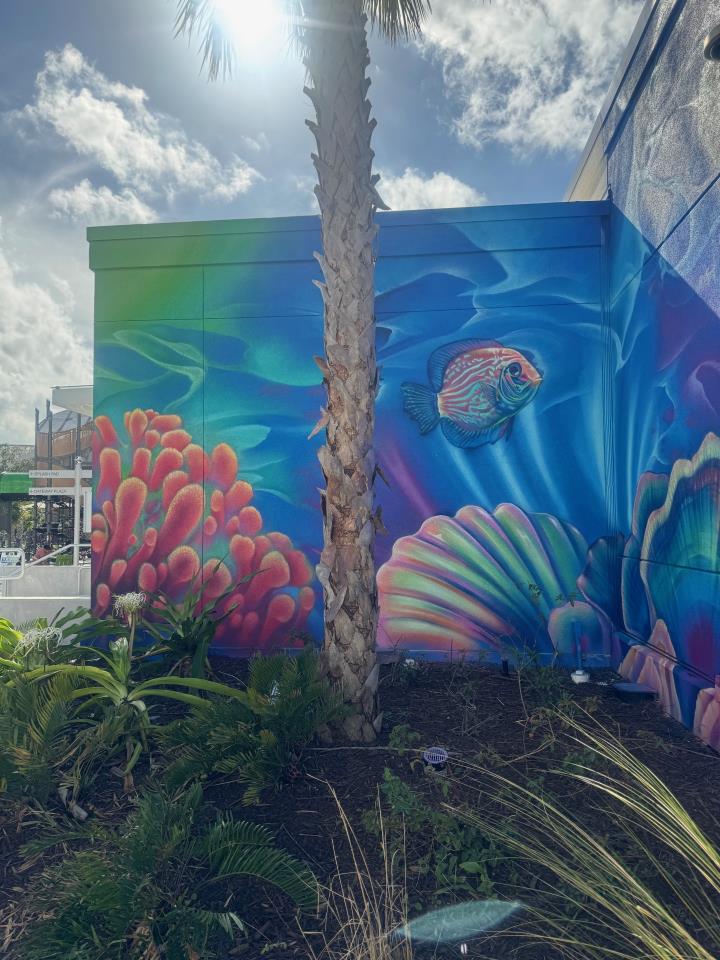 Image of underwater mural with palm tree in front
