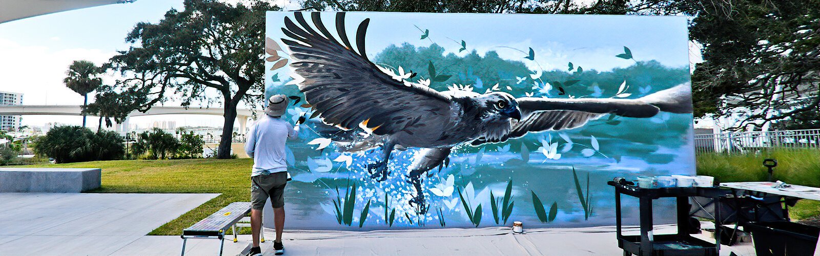 Artist working on osprey mural