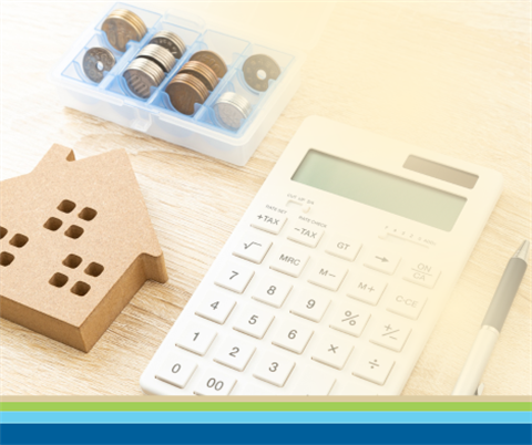 Stock photo of a calculator with pencil and coins.