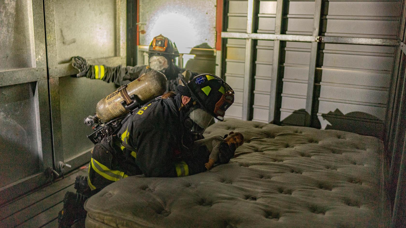 firefighters in smoky room trying to find a baby