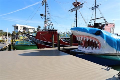 Clearwater marina with a boat built like a pirate ship and another like a shark.