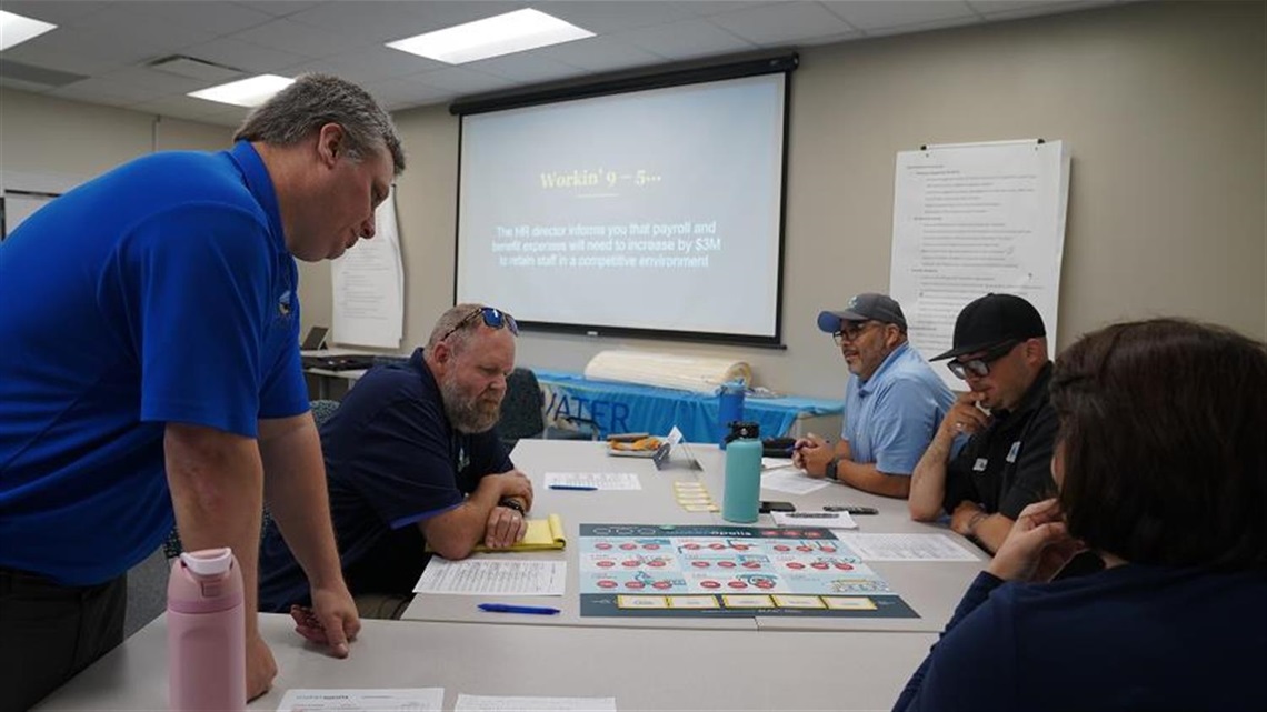 People at a table working on a workshop problem.